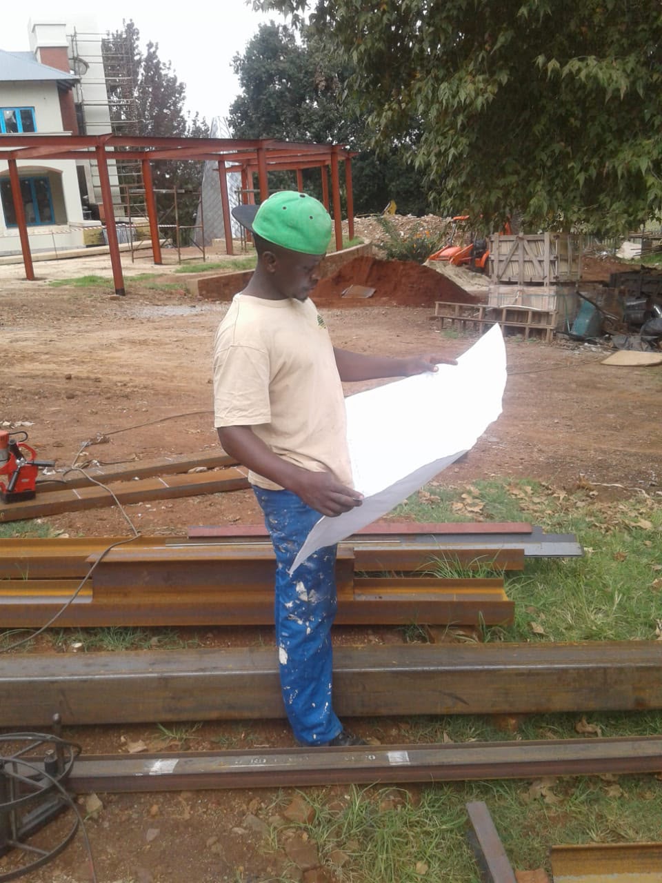 TrevorTech reviewing structural steel plans on site